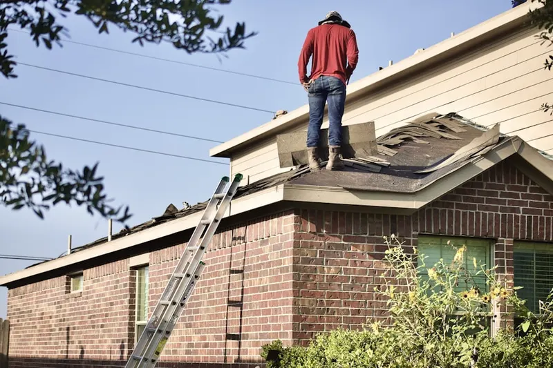 Professional roofer working on a residential roof in Key Center